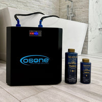 An Osone Chiller with a digital display and blue accents, shown alongside two Sirona Blue liquid bottles on a light wood floor in front of a white bathtub.
